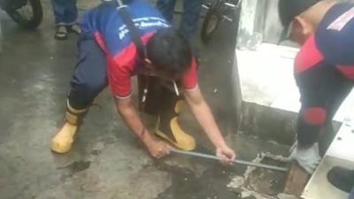 Petugas BPBD Kota Tangerang mengevakuasi ular sanca yang mnyumbat di gorong-gorong - Foto: Dok Pemkot Tangerang -